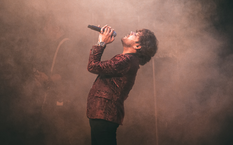 man singing on stage